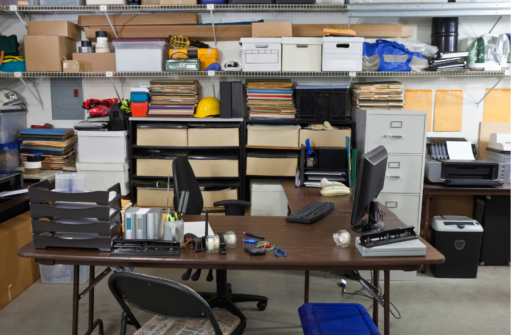 An office space with cluttered desks, overflowing trash bins, and dusty surfaces, illustrating the need for professional cleaning services.